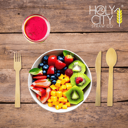 Holy City Straw Co. unwrapped bamboo cutlery next to color fruit place setting