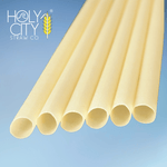 Close-up of natural bamboo fiber drinking straws from Holy City Straw Co. arranged in a fan pattern on a light blue background, showcasing smooth texture and sustainable material composition.