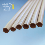 Jumbo reed stem drinking straws by Holy City Straw Co. displayed against a blue backdrop, highlighting their natural hollow texture and sustainable composition